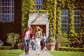 Study Students walking in front of the University entrance